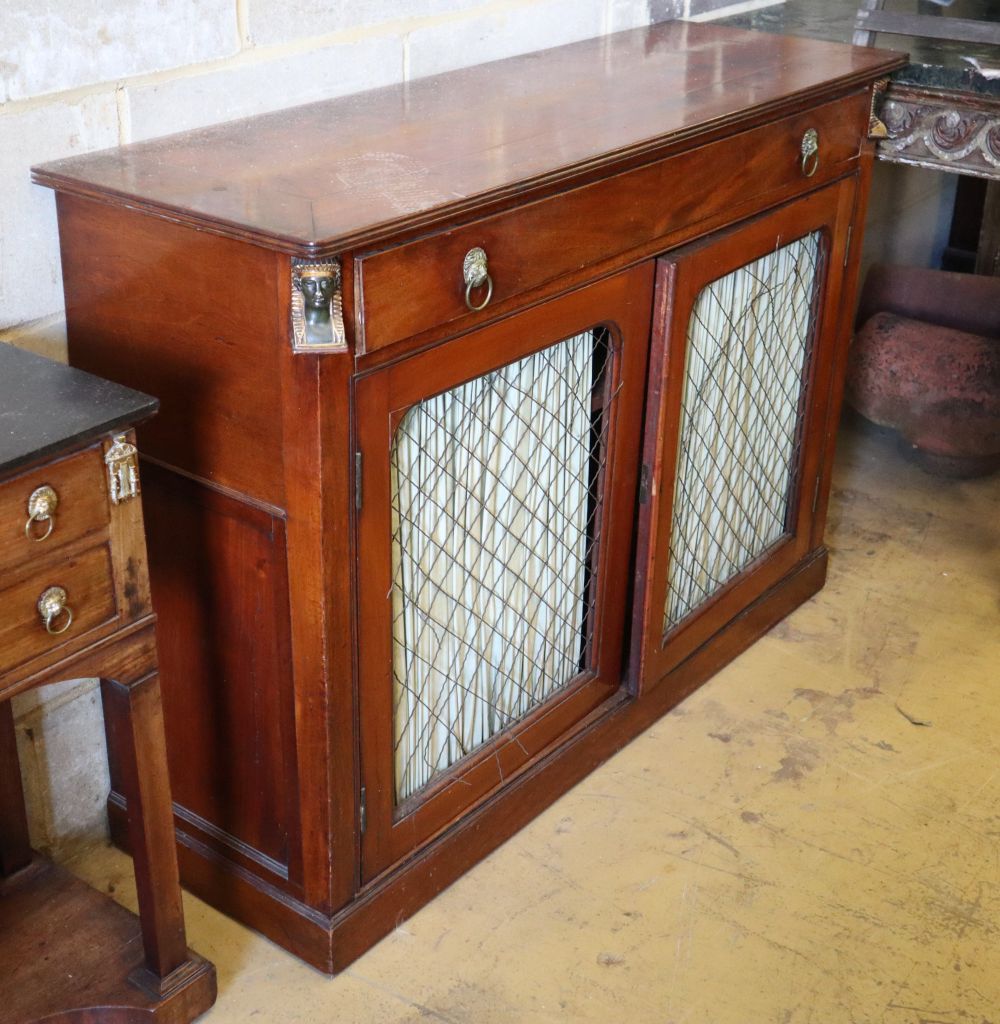 A pair of Regency mahogany side cabinets, with applied gilt metal Egyptian motifs, W.120cm, D.39cm, H.86cm